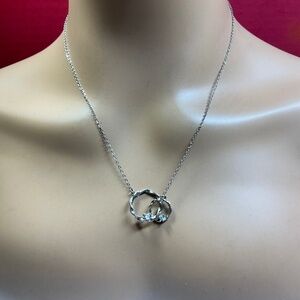 Sterling Silver intertwined twisted circles pendant with clear stones. 16 to 18”